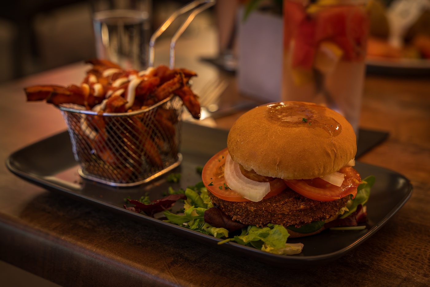 Burger mit S&uuml;&szlig;kartoffelpommes auf dem Teller im Restaurant der Bodetal Therme